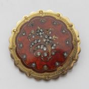A GOLD AND ENAMLE BROOCH