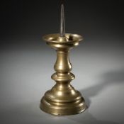 A BALUSTRE SHAPED BRASS CANDLESTICK