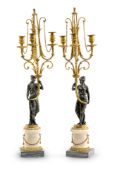A PAIR OF LOUIS XVI ORMOLU AND PATINATED BRONZE THREE LIGHT GIRANDOLES