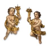 A PAIR OF BAROQUE ANGELS WITH CANDLESTICKS