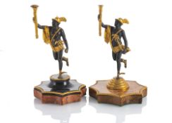 A PAIR OF PATINATED AND GILTBRONZE FIGURES OF MERCURY WITH TORCHES