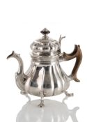 A BAROQUE SILVER TEA POT