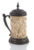 A LARGE BAROQUE STYLE SILVER MOUNTED IVORY TANKARD