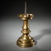 A BALUSTRE SHAPED BRASS CANDLESTICK