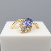 A Yellow Gold Ring Set With Pear-Shaped Tanzanite & Round Brilliant-Cut Diamonds