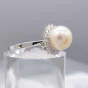 A White Gold Pearl Ring With Diamond Surround
