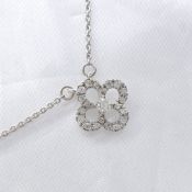A Diamond-Set Quatrefoil Pendant With Integral Chain, In White Gold