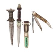 AN INDO PERSIAN DAGGER, A TUAREG DAGGER AND A FOLDING FISH KNIFE