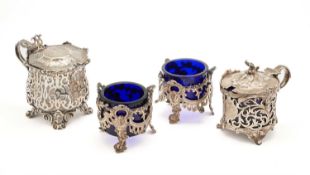 A PAIR OF VICTORIAN OPENWORK SILVER SALT CELLARS AND TWO VICTORIAN OPENWORK SILVER MUSTARD POTS
