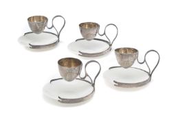 A SET OF FOUR EDWARDIAN SILVER PATENT EGG CUP STANDS, ALFRED CLARK, LONDON, 1906