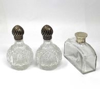 A PAIR OF VICTORIAN CUT-GLASS SCENT BOTTLES WITH SILVER COVERS, CHARLES HENRY DUMENIL, LONDON, 1889