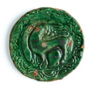 A CIRCULAR RELIEF TILE, PROBABLY GHAZNI, AFGHANISTAN, CIRCA 1200
