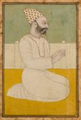 A KNEELING COURTIER, RAJASTHAN, NORTHERN INDIA, CIRCA 1800