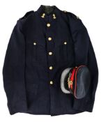 A GEORGE V PEAKED CAP AND TUNIC OF AN OFFICER OF THE ROYAL ARTILLERY