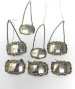 A GROUP OF SEVEN SILVER BOTTLE TICKETS (WINE LABELS)