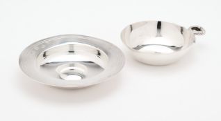 A SILVER TASTEVIN AND A SILVER MINIATURE 'ARMADA DISH'