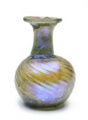 A ROMAN GREEN GLASS SPRINKLER FLASK, CIRCA 3RD/4TH CENTURY A.D.