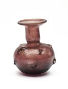 A ROMAN PURPLE GLASS SPRINKER FLASK, CIRCA 3RD/4TH CENTURY A.D.