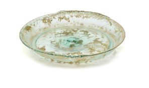 A ROMAN GREEN GLASS SHALLOW DISH, CIRCA 2ND CENTURY A.D.