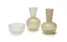 THREE ROMAN PALE GLASS VESSELS, CIRCA 2ND-4TH CENTURY A.D.