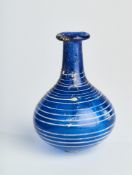 A COBALT BLUE GLASS BOTTLE, ROMAN, CIRCA 1ST CENTURY A.D.