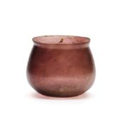 A ROMAN MANGANESE PURPLE GLASS BEAKER, CIRCA 1ST CENTURY A.D.