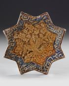 A STAR-SHAPED KASHAN TILE, PERSIA, 13TH–14TH CENTURY