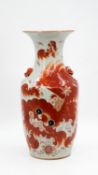 A Chinese Qianjiang porcelain vase - decorated with Fu lions and red ringed lion-head handles