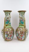 A Chinese Canton pair of Famille Rose decorated porcelain vases - with figurative palace and nature 