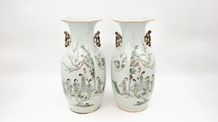 A Chinese pair of Qianjiang cai decorated porcelain vases - with decor of ladies in a garden