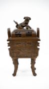 A Chinese patinated bronze and footed and covered incence burner