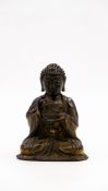 A Chinese antique gilt and patinated bronze sculpture of seated Buddha