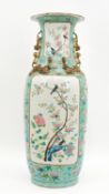 A Chinese Canton and Famille Rose decorated porcelain vase on a turquoise fond background