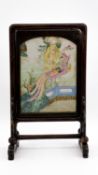 A Chinese Famille Rose porcelain plaque - mounted in an exotic wooden standing frame