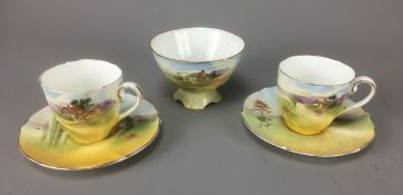 Royal Doulton "English Cottage" Pair of Teacups and Saucers together with the Sugar Bowl.