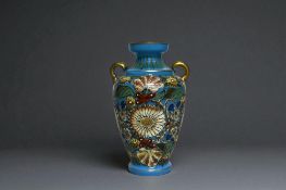 A Bohemian hand painted 'Persian' style vase. Blue ground, with hand painted Persian inspired foliat