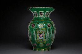 A Bohemian facet cut & enamel painted green glass vase. Circa 1900. Height - 20cm 