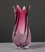 A large cranberry glass vase. Spiral form. 
