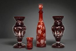 A collection of Bohemian Egermann Ruby glass. Including a cut to clear decanter, with Grape & vine d