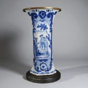 A Boch FrÃ¨res Keramis Delft blue & white vase. Mounted on wooden stand with brass top. Height - 32c