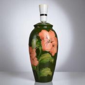 A Moorcroft table lamp. 'Hibiscus' pattern. Height - 35cm 
