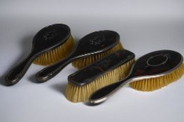 A collection of sterling silver mounted Tortoiseshell brushes. Fine stylised inlay. 