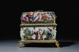 A vintage Capodimonte porcelain casket. Relief decorated with Bacchantes. Stood on gilt metal legs. 