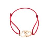 Dinh Van, centre de bracelet or rose 750 composé de deux coeurs entrelacés sur un cordon en tissu ro