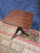 A Mahogany Square Table The Top Raised Above A Baluster Pedestal With Three Splayed Legs Ending In
