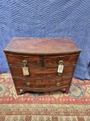 A Mahogany Veneered Bow Fronted Chest Of Two Short And Two Long Drawers With A Shaped Apron And