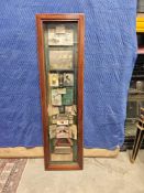 A Vintage Shadow Box Or Display Case Primarily Featuring Memorabilia And Advertisements Related To