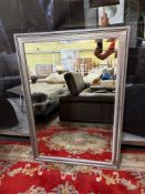 A large, rectangular mirror with a wide, ornate silver-coloured frame, bevelled mirror plate 85 x