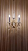 Pair of Crystal Three-Arm Wall Sconces with Brass Backplate: This elegant pair of three-arm wall