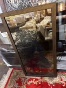 A striking rectangular accent mirror, featuring a unique silhouette of a tree seamlessly